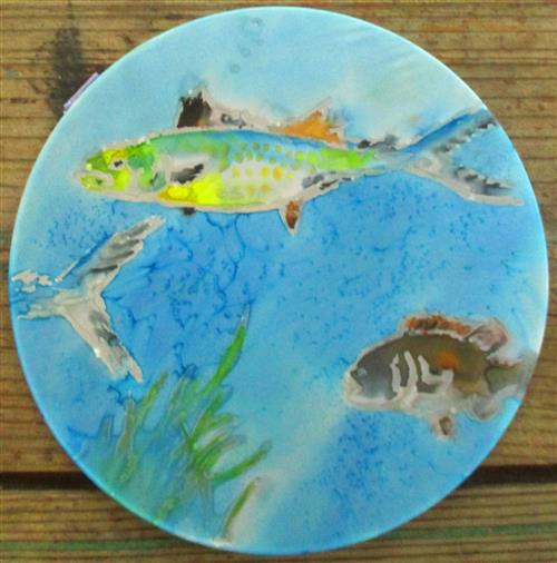Round painting of colorful fish underwater